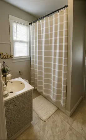 a bathroom with a sink a toilet a mirror and shower