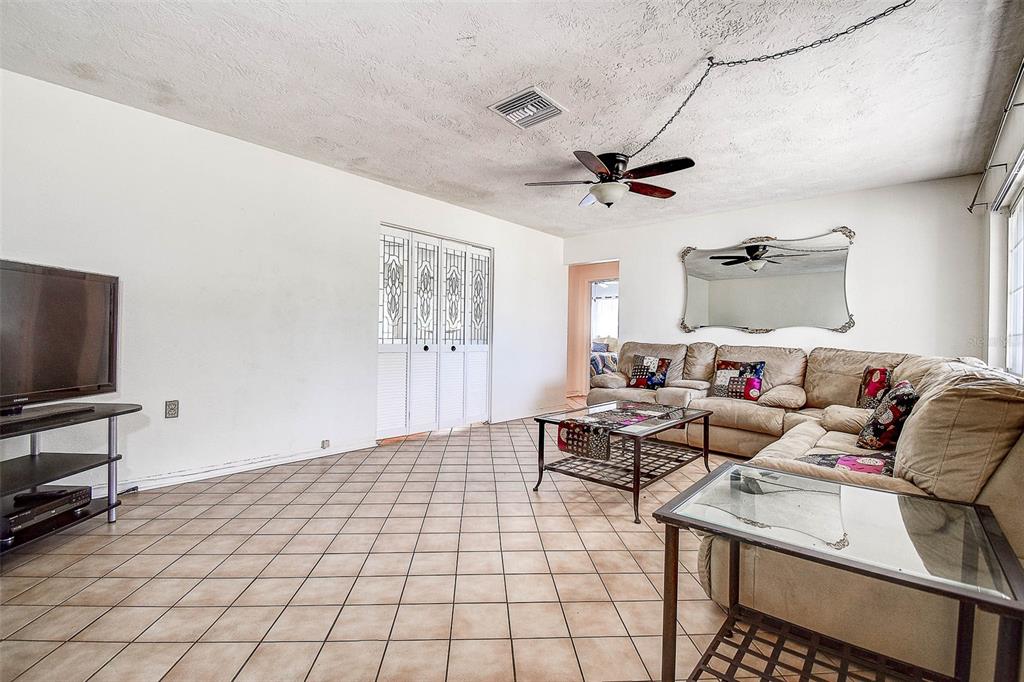 8601 139th Street Seminole, FL 33776 - Photo 28 of 47 a living room with furniture and a flat screen tv