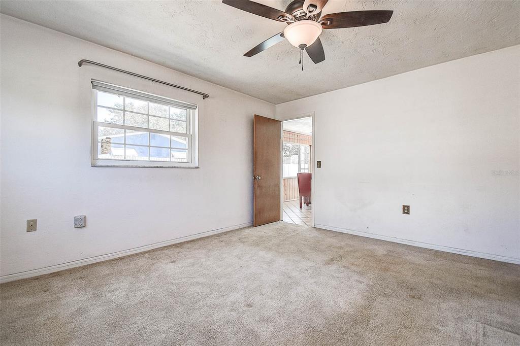 8601 139th Street Seminole, FL 33776 - Photo 38 of 47 an empty room with a window and a fan