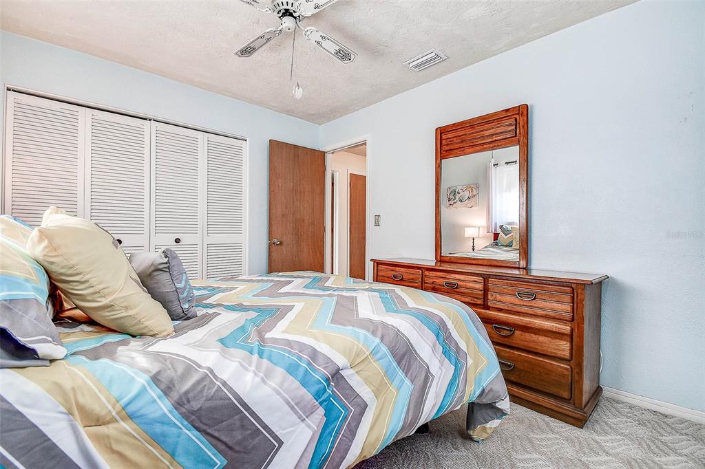 8601 139th Street Seminole, FL 33776 - Photo 43 of 47 a bedroom with a bed and a chandelier