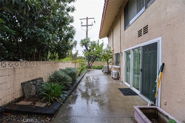 a view of a hallway with wooden floor and a living room