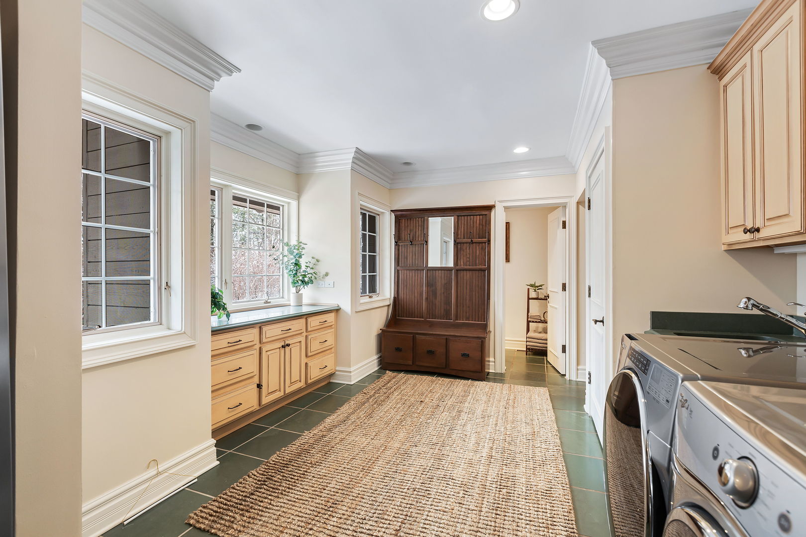 1560 South Ridge Road Lake Forest, IL 60045 - Photo 15 of 27 a kitchen with granite countertop a refrigerator a stove top oven with white cabinets and wooden floor