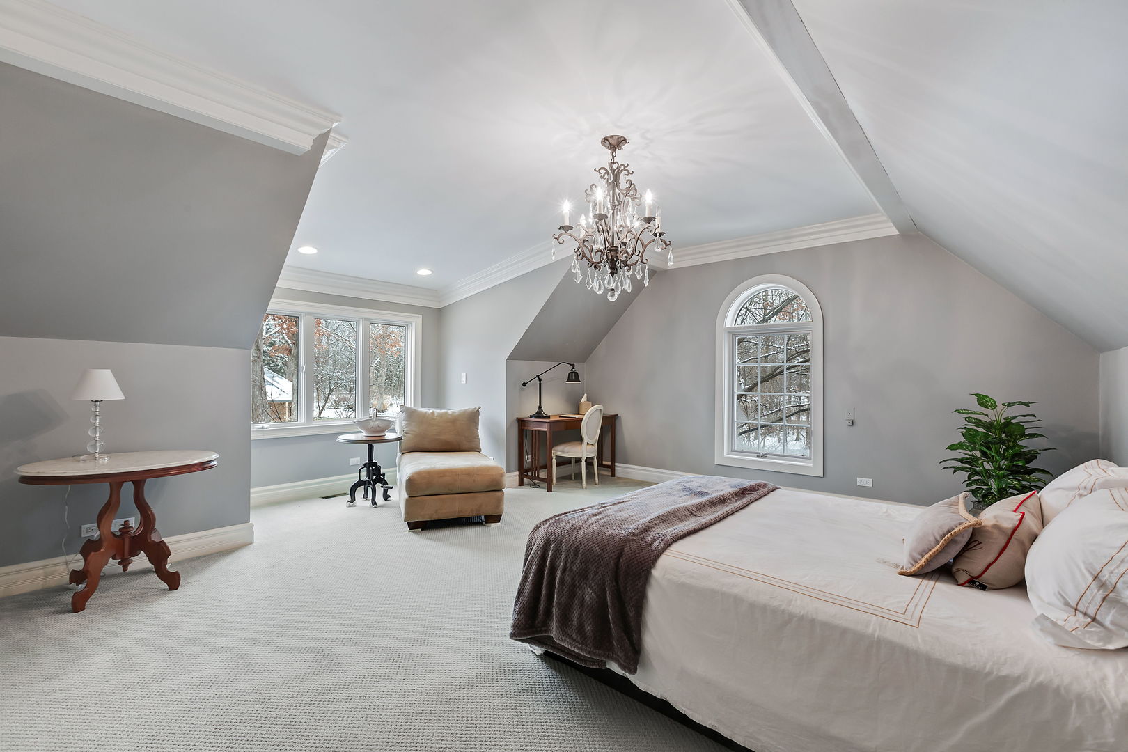 1560 South Ridge Road Lake Forest, IL 60045 - Photo 21 of 27 a spacious bedroom with a bed a chandelier and a couch