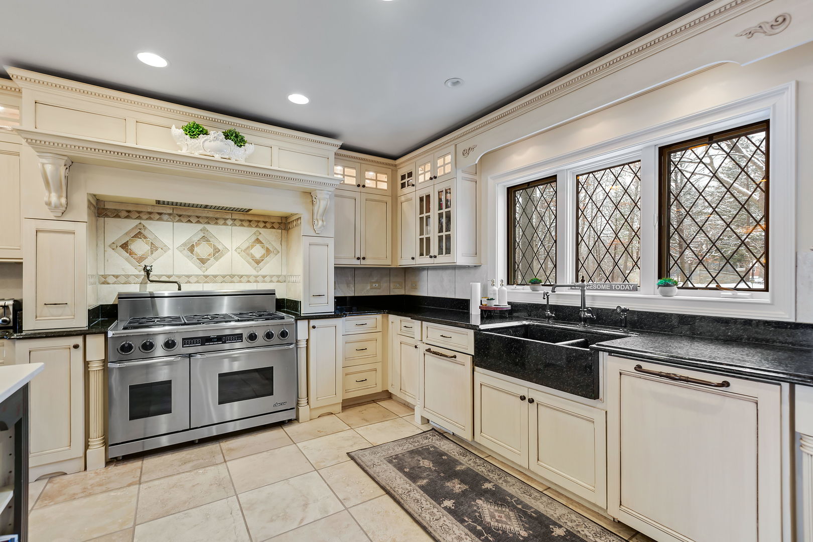 1560 South Ridge Road Lake Forest, IL 60045 - Photo 7 of 27 a kitchen with stainless steel appliances granite countertop a stove a sink and a granite counter tops