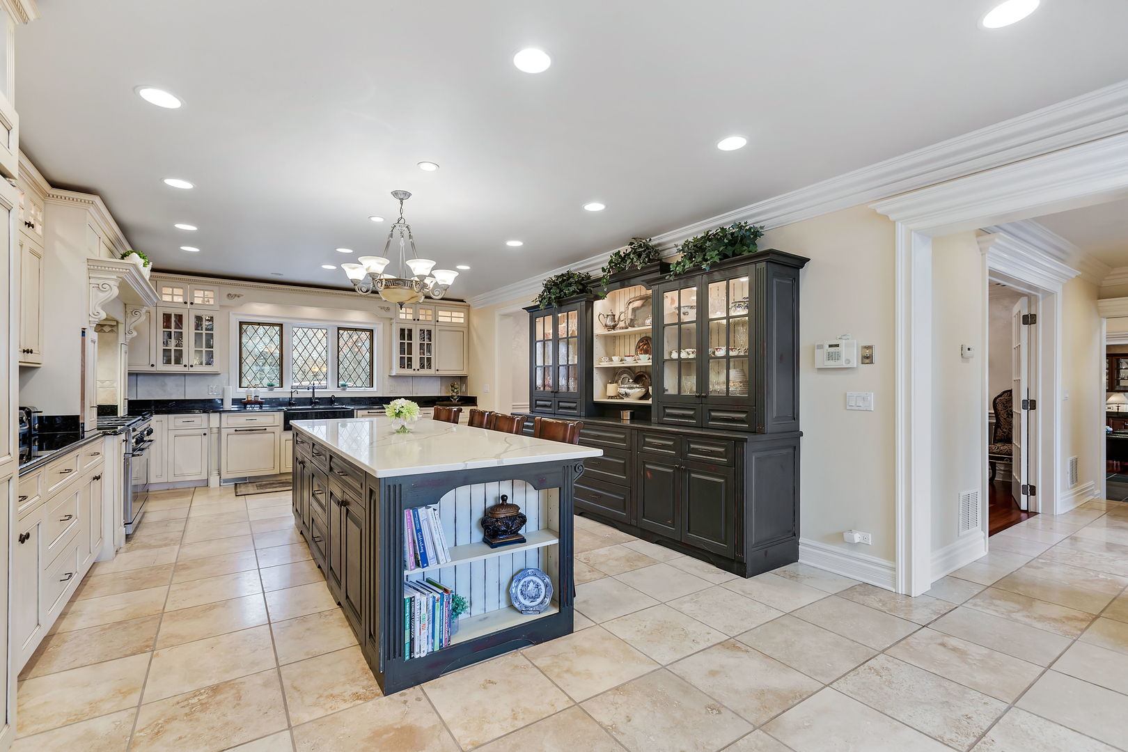1560 South Ridge Road Lake Forest, IL 60045 - Photo 8 of 27 a kitchen with kitchen island granite countertop a stove and a refrigerator