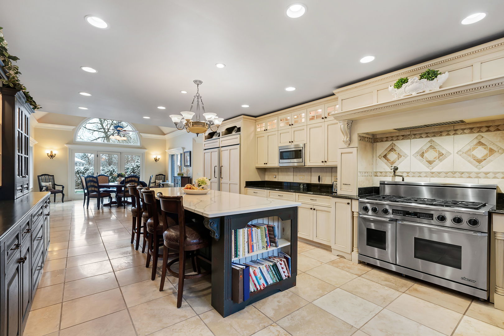 1560 South Ridge Road Lake Forest, IL 60045 - Photo 10 of 27 a kitchen with stainless steel appliances a stove a sink a dining table and chairs
