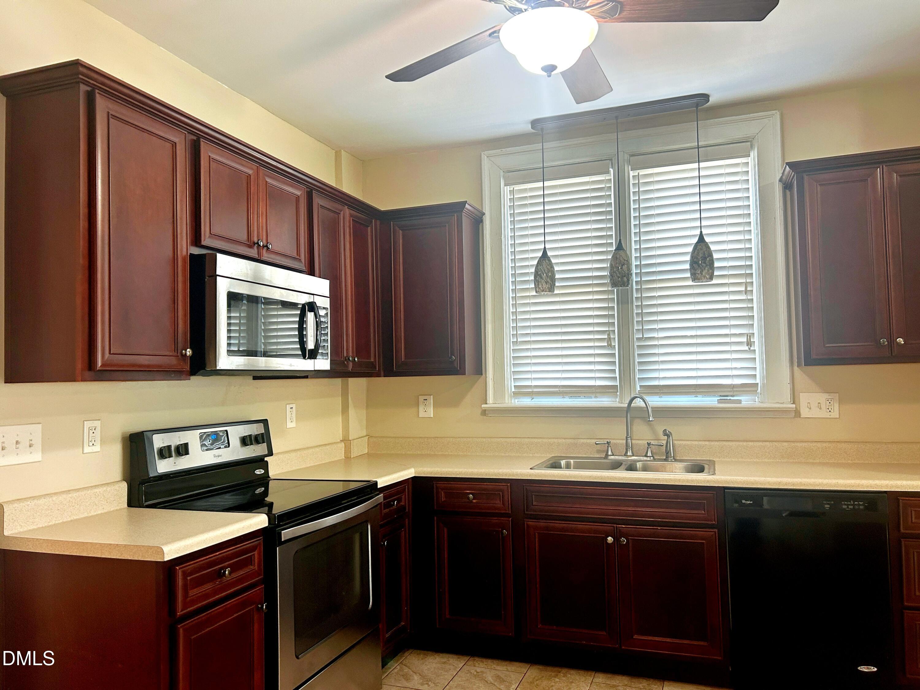 405 Sunset Avenue Clinton, NC 28328 - Photo 7 of 47 a kitchen with stainless steel appliances granite countertop a sink stove and microwave