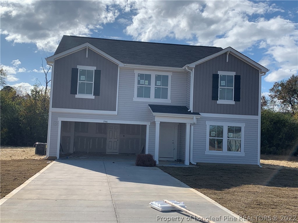 5946 Lowgrass Road Stedman, NC 28391 - Photo 1 of 4 a front view of a house with a yard and garage