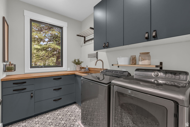1766 West Tollgate Cyn Road Coalville, UT 84017 - Photo 12 of 59 Laundry room featuring dark gray cabinetry, wood-finish countertops, and a patterned tile floor