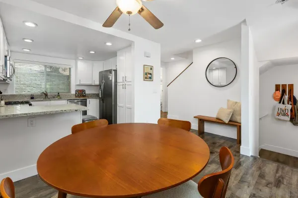 a view of a kitchen with granite countertop a sink a window and a dining table