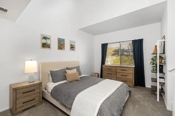 a bedroom with a bed and cabinets