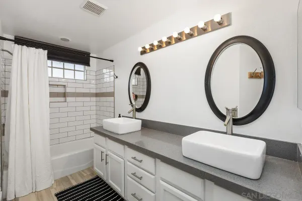 a bathroom with a sink a mirror and a shower