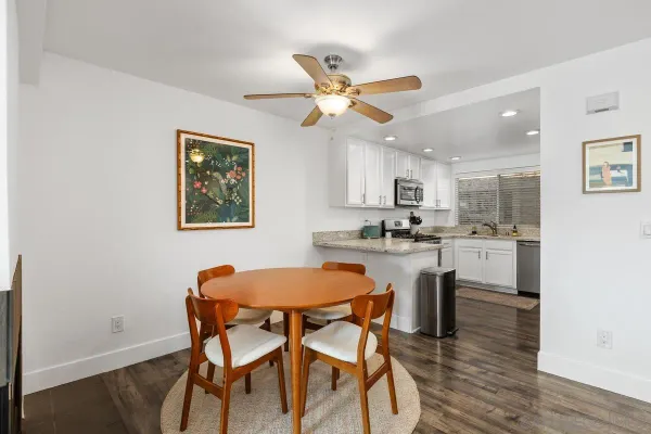 a kitchen with a table chairs and a refrigerator