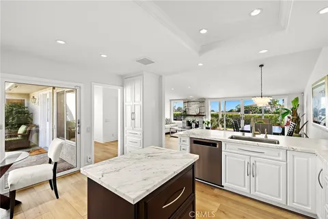 a kitchen with a sink a stove and chairs