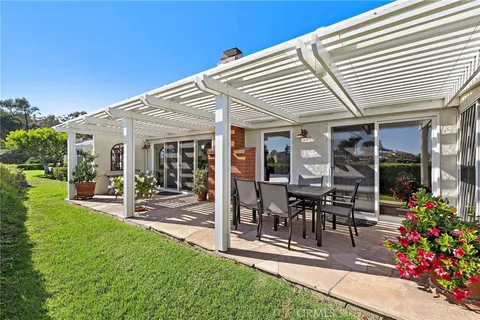 a view of a patio with table and chairs and potted plants