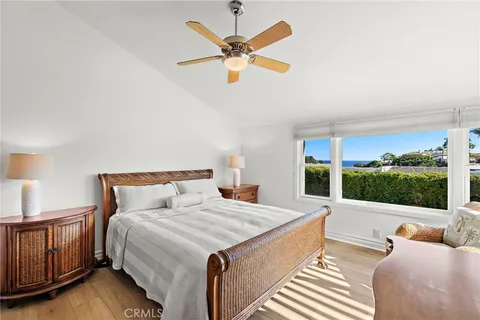 a large bedroom with a bed and window