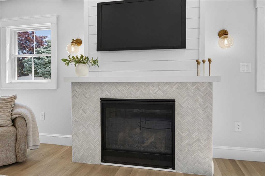 20 Saltonstall Road Medford, MA 02155 - Photo 5 of 41 a living room with a fireplace and a flat screen tv