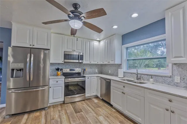 a kitchen with kitchen island granite countertop a sink stainless steel appliances and counter space