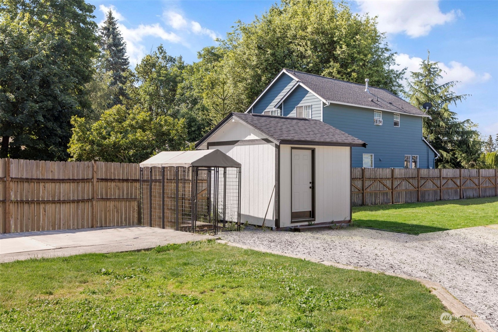 1702 Griffin Avenue Enumclaw, WA 98022 - Photo 26 of 27 a view of a house with a small yard and wooden fence