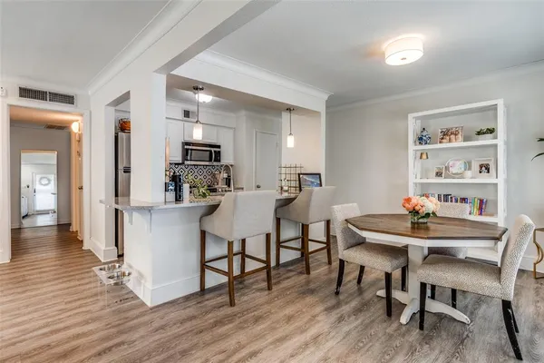 a view of a dining room with furniture and wooden floor