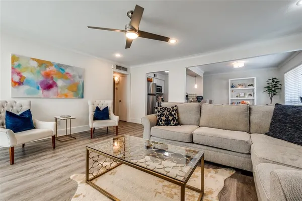 a living room with furniture a rug and a chandelier