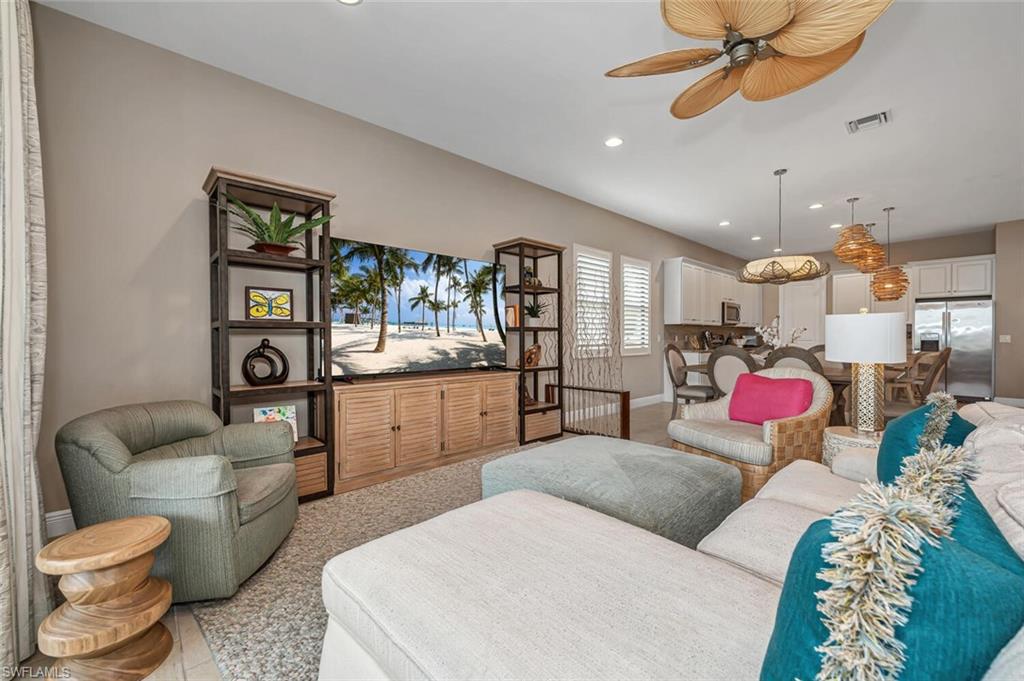 4741 Formosa Drive Naples, FL 34119 - Photo 12 of 18 a living room with furniture a chandelier and a rug