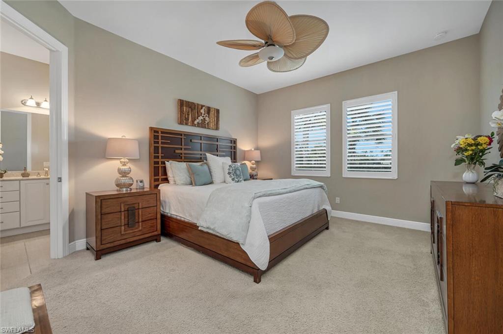 4741 Formosa Drive Naples, FL 34119 - Photo 15 of 18 a bedroom with a bed and a chandelier