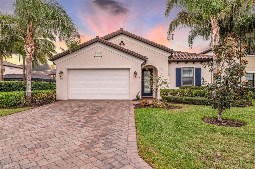 4741 Formosa Drive Naples, FL 34119 - Photo 2 of 18 a front view of house with yard and green space
