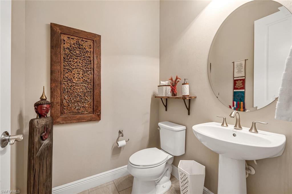4741 Formosa Drive Naples, FL 34119 - Photo 5 of 18 a bathroom with a toilet sink and mirror