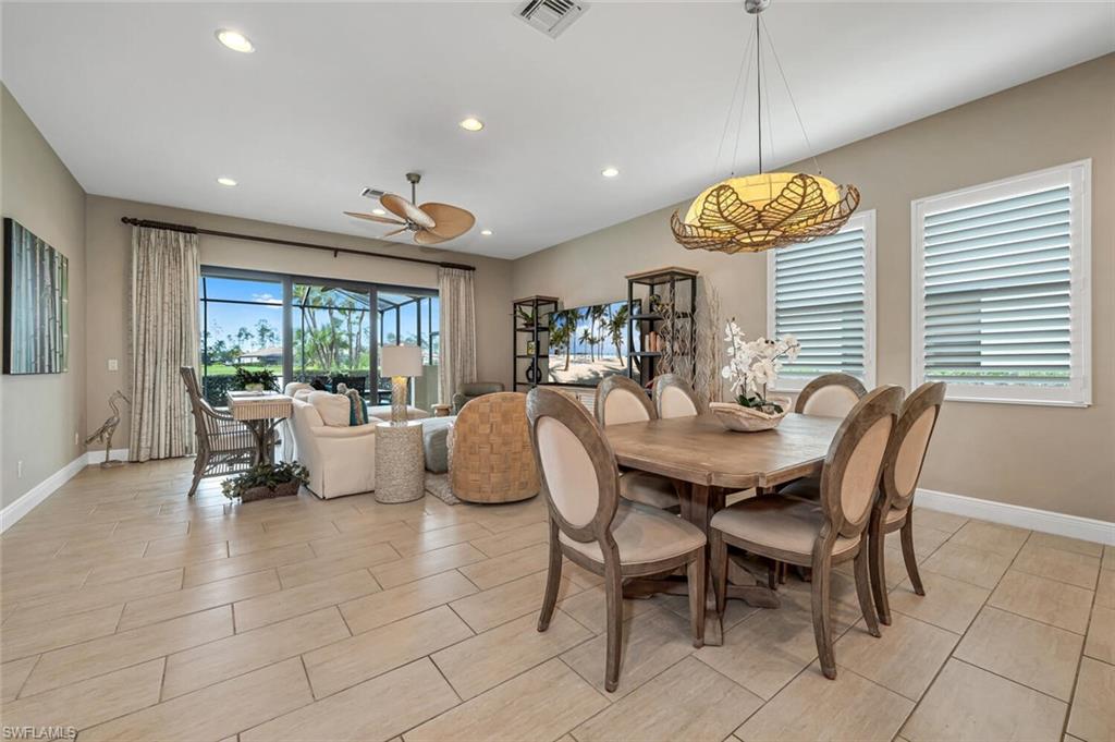 4741 Formosa Drive Naples, FL 34119 - Photo 10 of 18 a view of a dining room and livingroom with furniture wooden floor and a chandelier