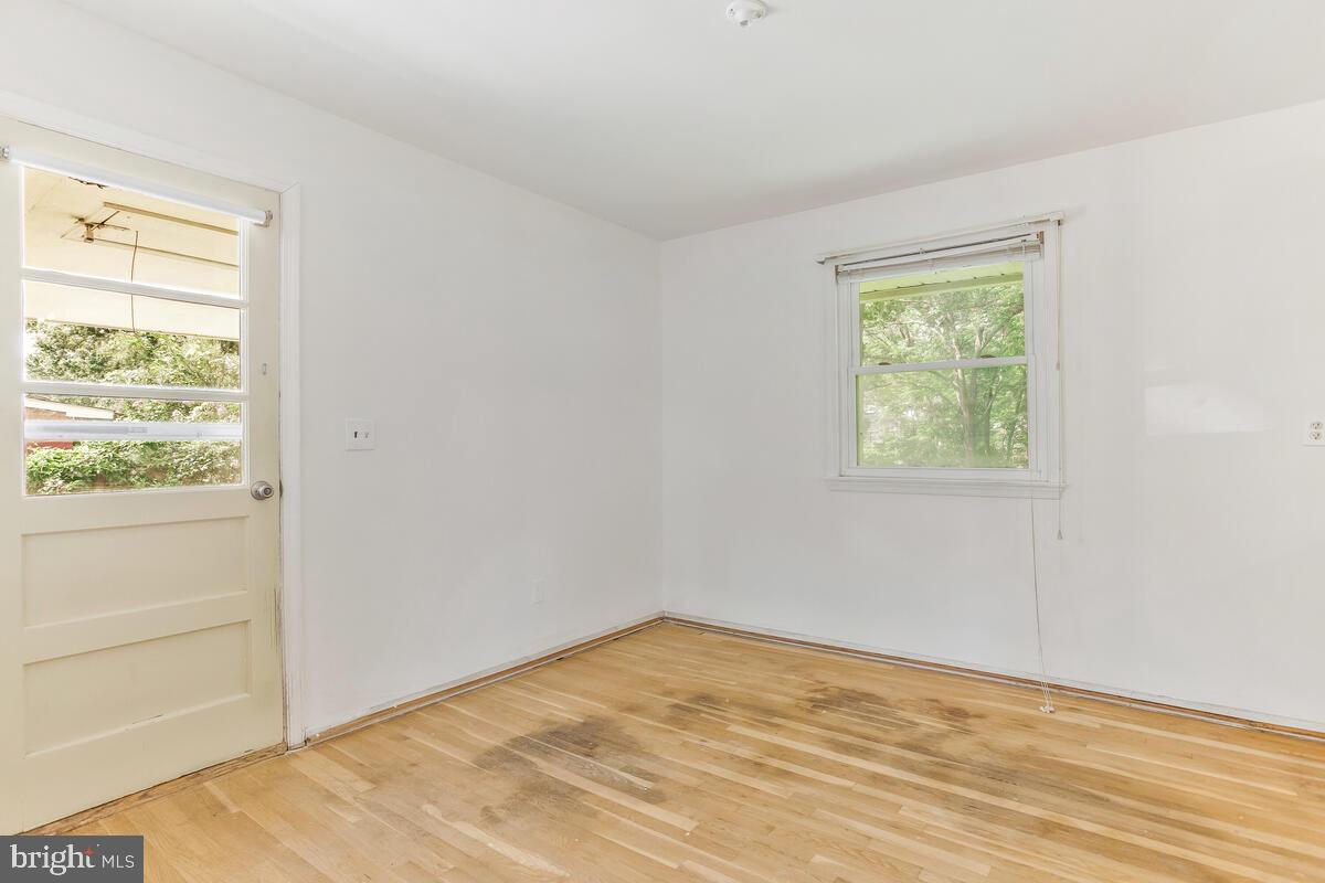 12412 Palermo Drive Silver Spring, MD 20904 - Photo 11 of 43 a view of empty room with wooden floor and fan