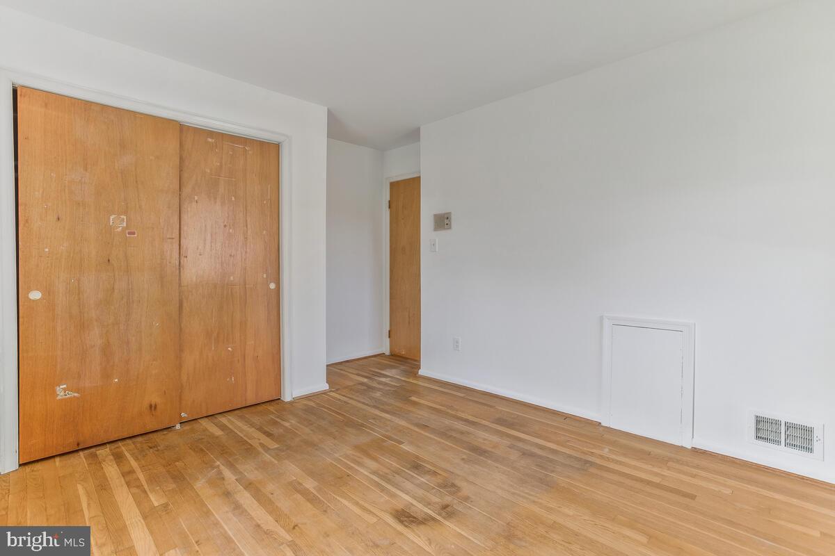 12412 Palermo Drive Silver Spring, MD 20904 - Photo 25 of 43 a view of an empty room with wooden floor and a window