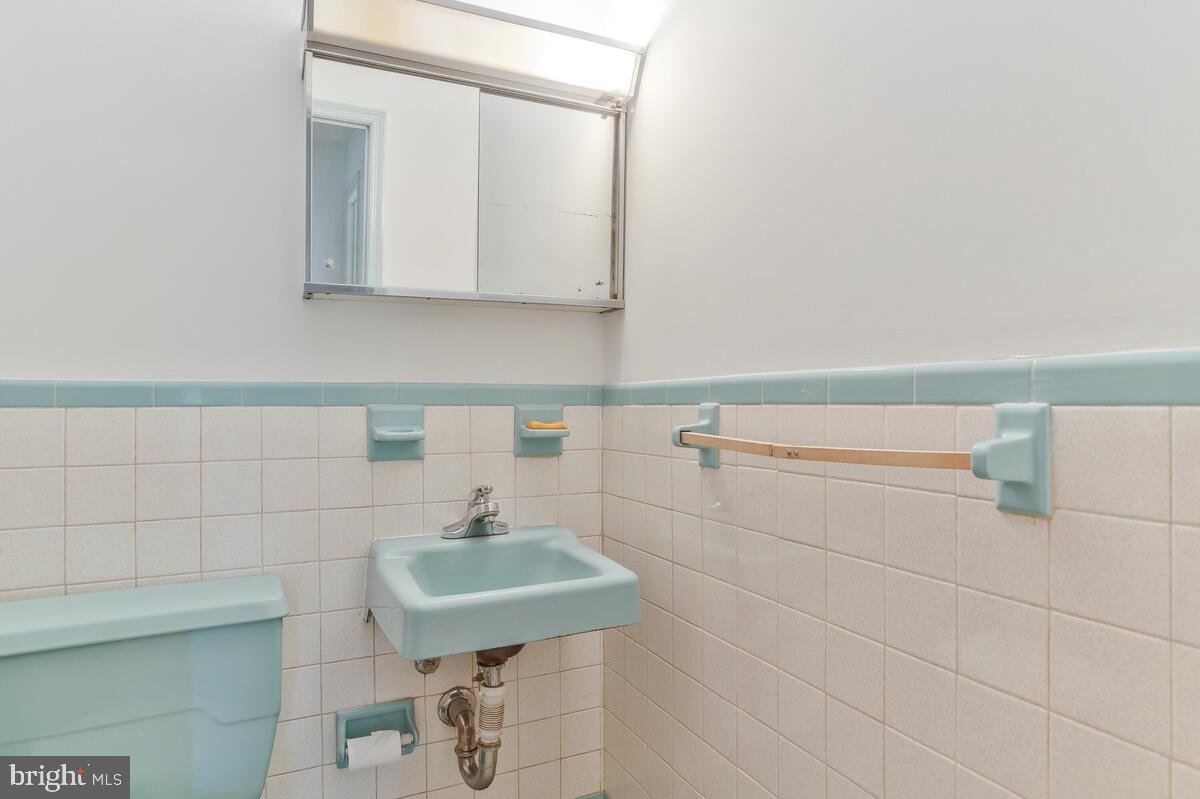 12412 Palermo Drive Silver Spring, MD 20904 - Photo 26 of 43 a bathroom with a sink a toilet and mirror