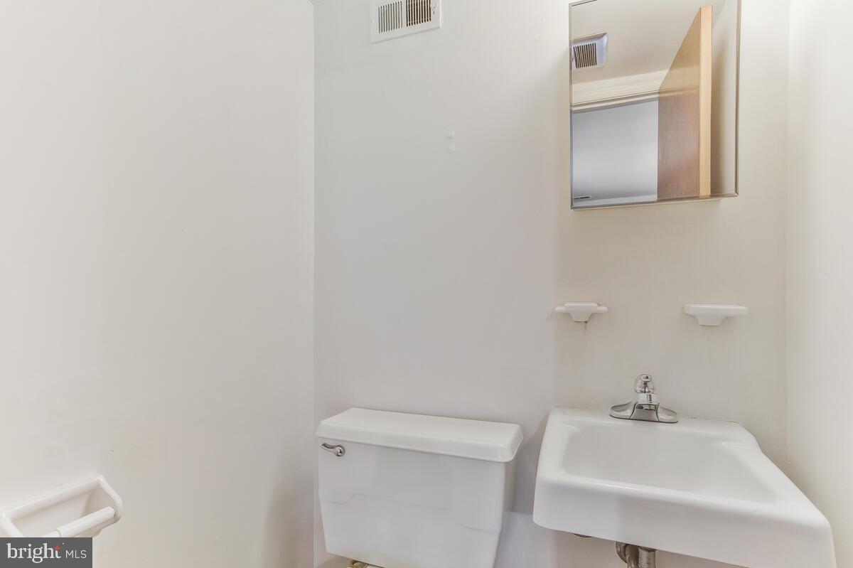 12412 Palermo Drive Silver Spring, MD 20904 - Photo 31 of 43 a bathroom with a sink a toilet and mirror