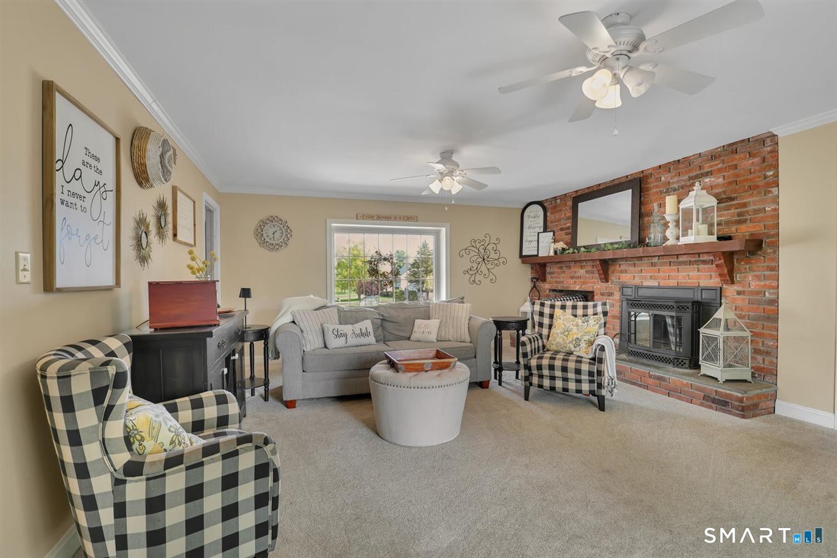 72 Old Post Road Wethersfield, CT 06109 - Photo 3 of 40 a living room with furniture a fireplace and a window