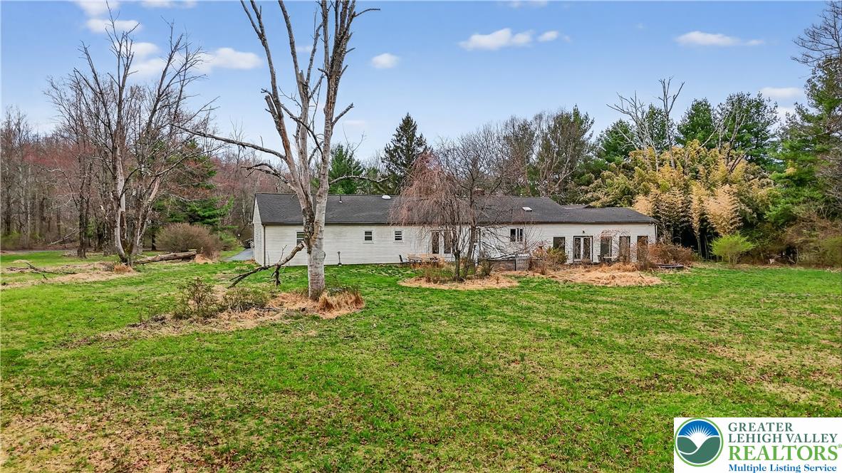 2197 Buck Run Road Quakertown, PA 18951 - Photo 12 of 45 A spacious backyard with mature trees surrounds this inviting home.