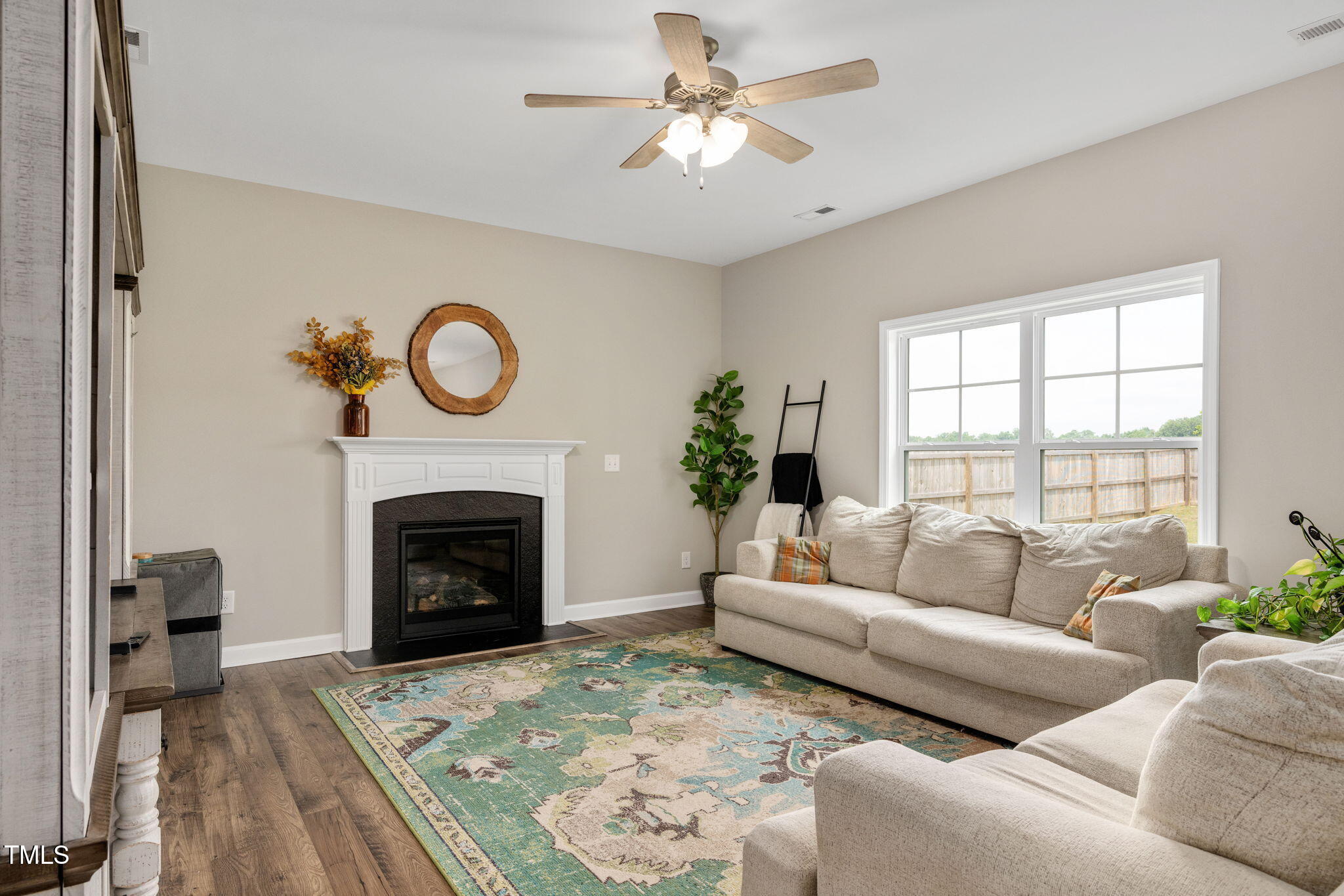40 Kenbridge Lane Princeton, NC 27569 - Photo 15 of 36 a living room with furniture a window and a fireplace