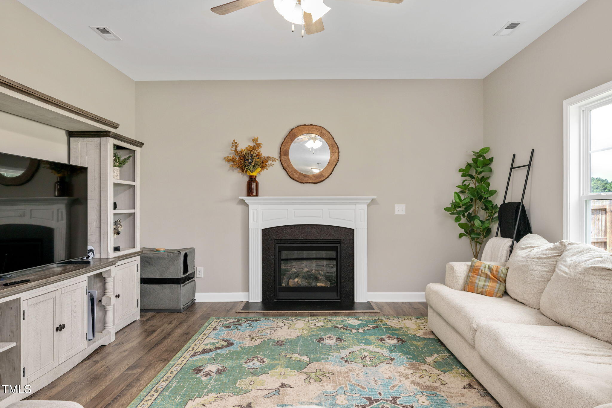 40 Kenbridge Lane Princeton, NC 27569 - Photo 16 of 36 a living room with furniture a fireplace and a flat screen tv