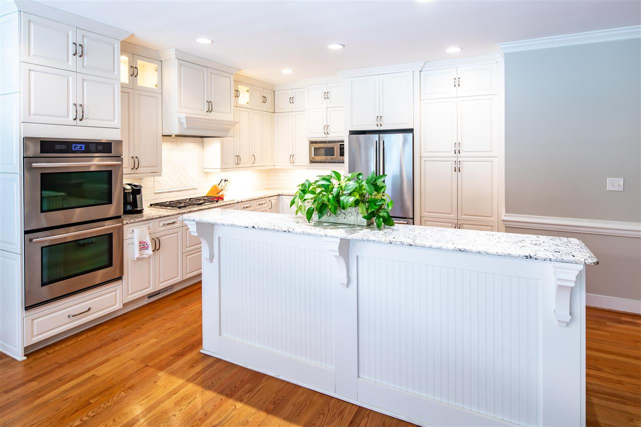 2709 Amstel Way Raleigh, NC 27613 - Photo 8 of 30 No detail missed in this Chef’s dream kitchen! Elegant tile backsplash, updated custom Ferguson cabinetry and hardware, granite countertops! Kitchen