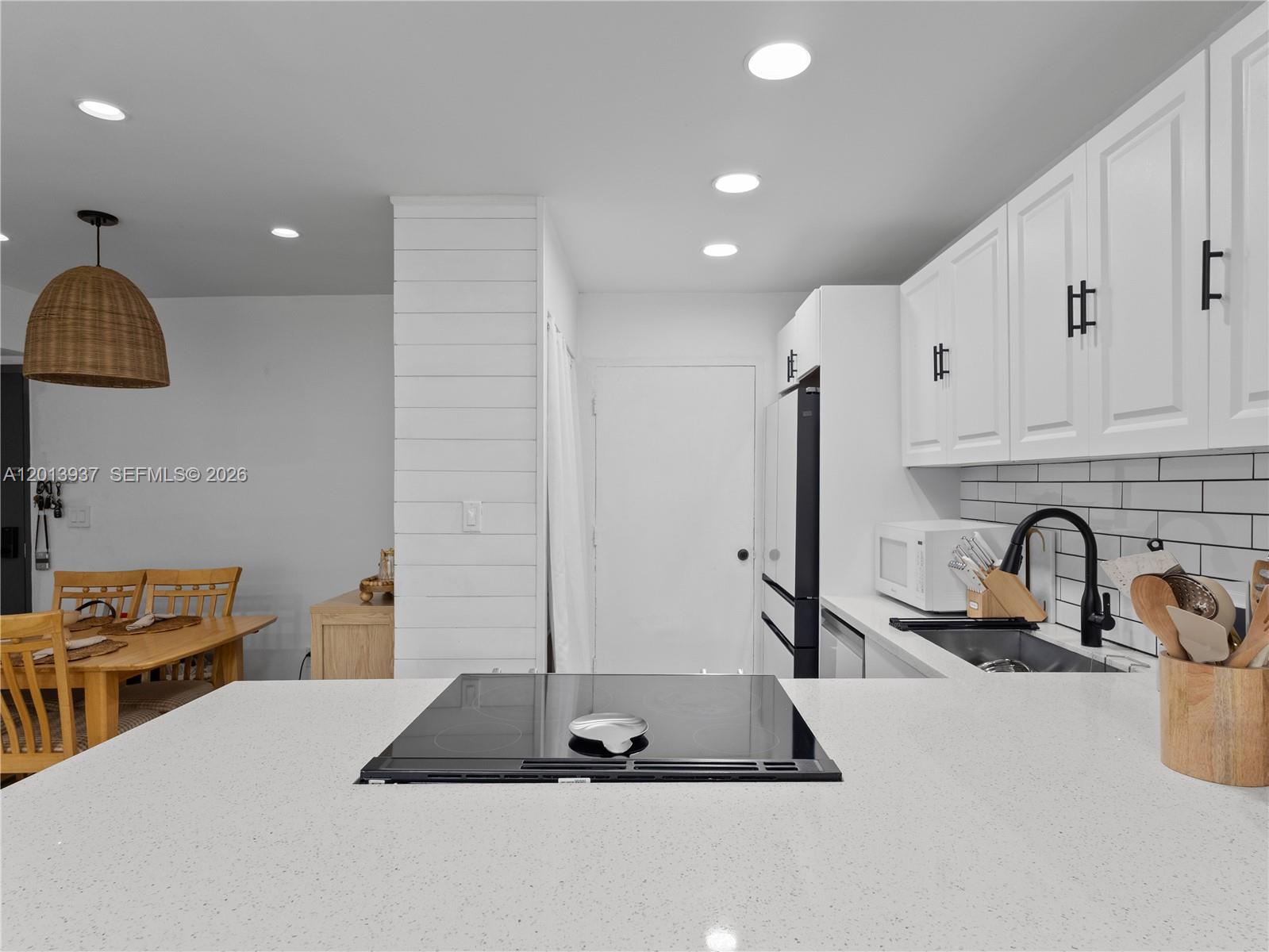 7487 Southwest 82nd Street, Unit C208 Miami, FL 33143 - Photo 11 of 28 a kitchen with sink a faucet and appliances