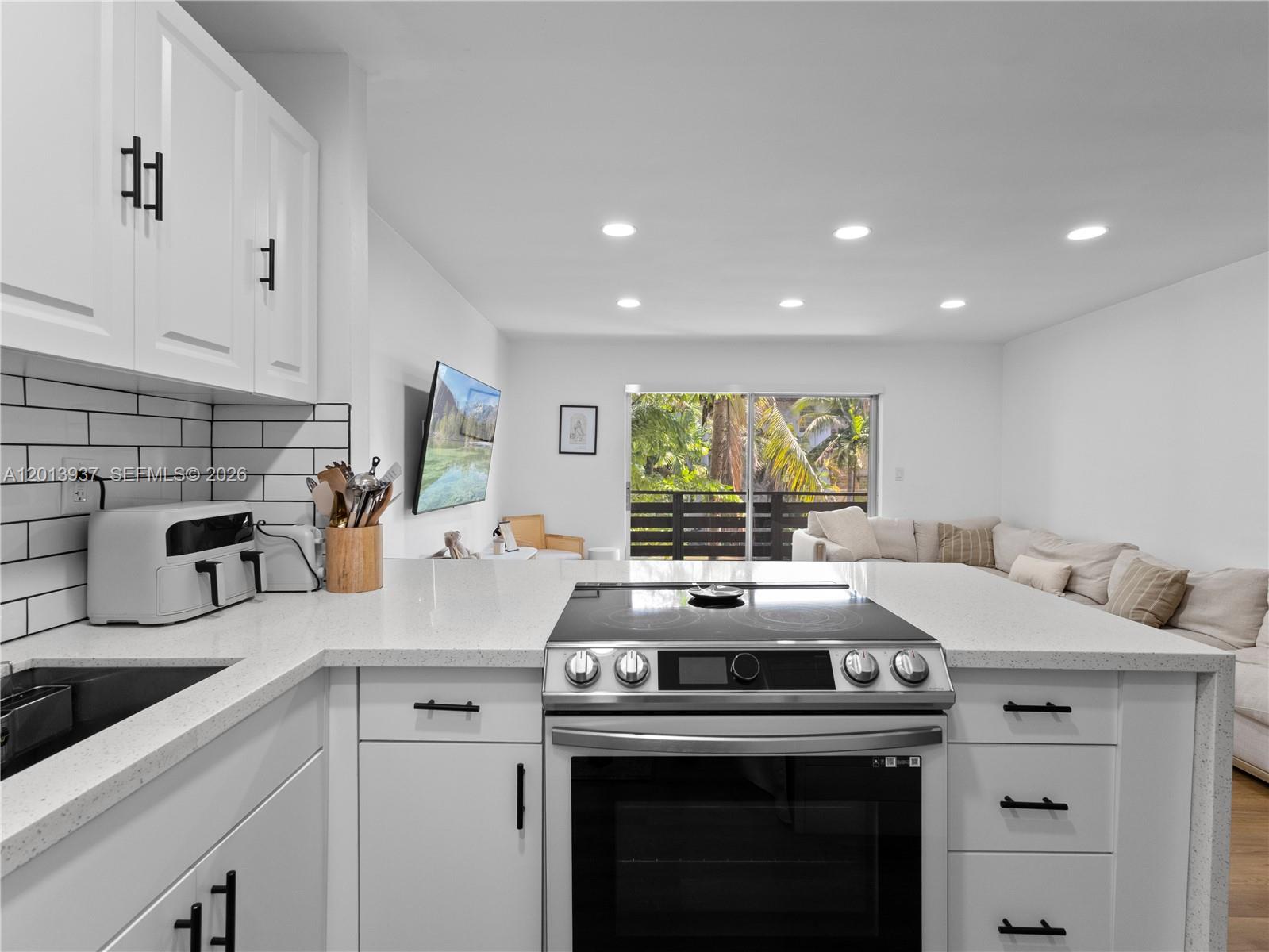7487 Southwest 82nd Street, Unit C208 Miami, FL 33143 - Photo 12 of 28 a kitchen with a stove and a sink
