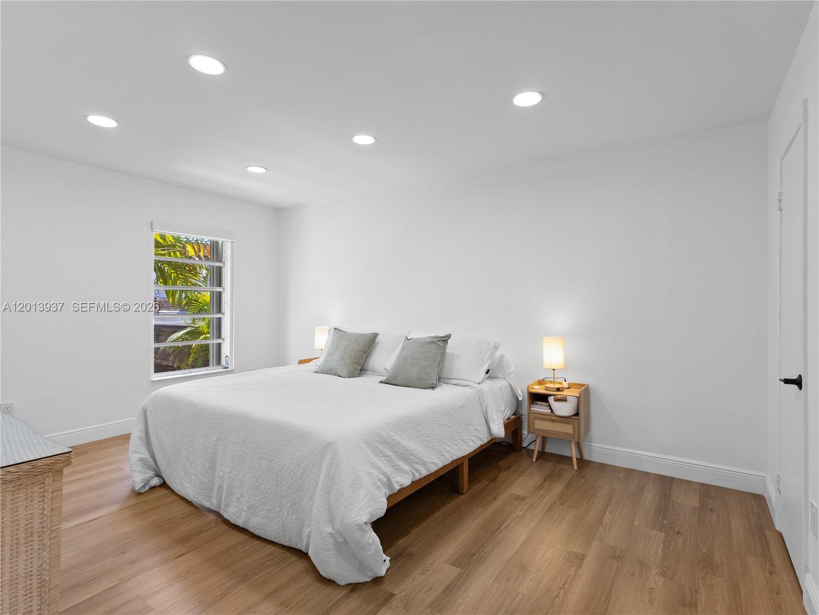 7487 Southwest 82nd Street, Unit C208 Miami, FL 33143 - Photo 13 of 28 a bedroom with a bed and a window