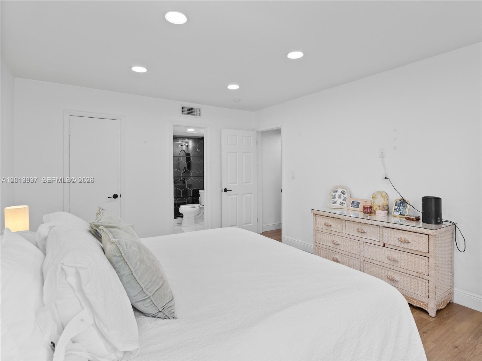 7487 Southwest 82nd Street, Unit C208 Miami, FL 33143 - Photo 14 of 28 a bedroom with a bed and a cabinets