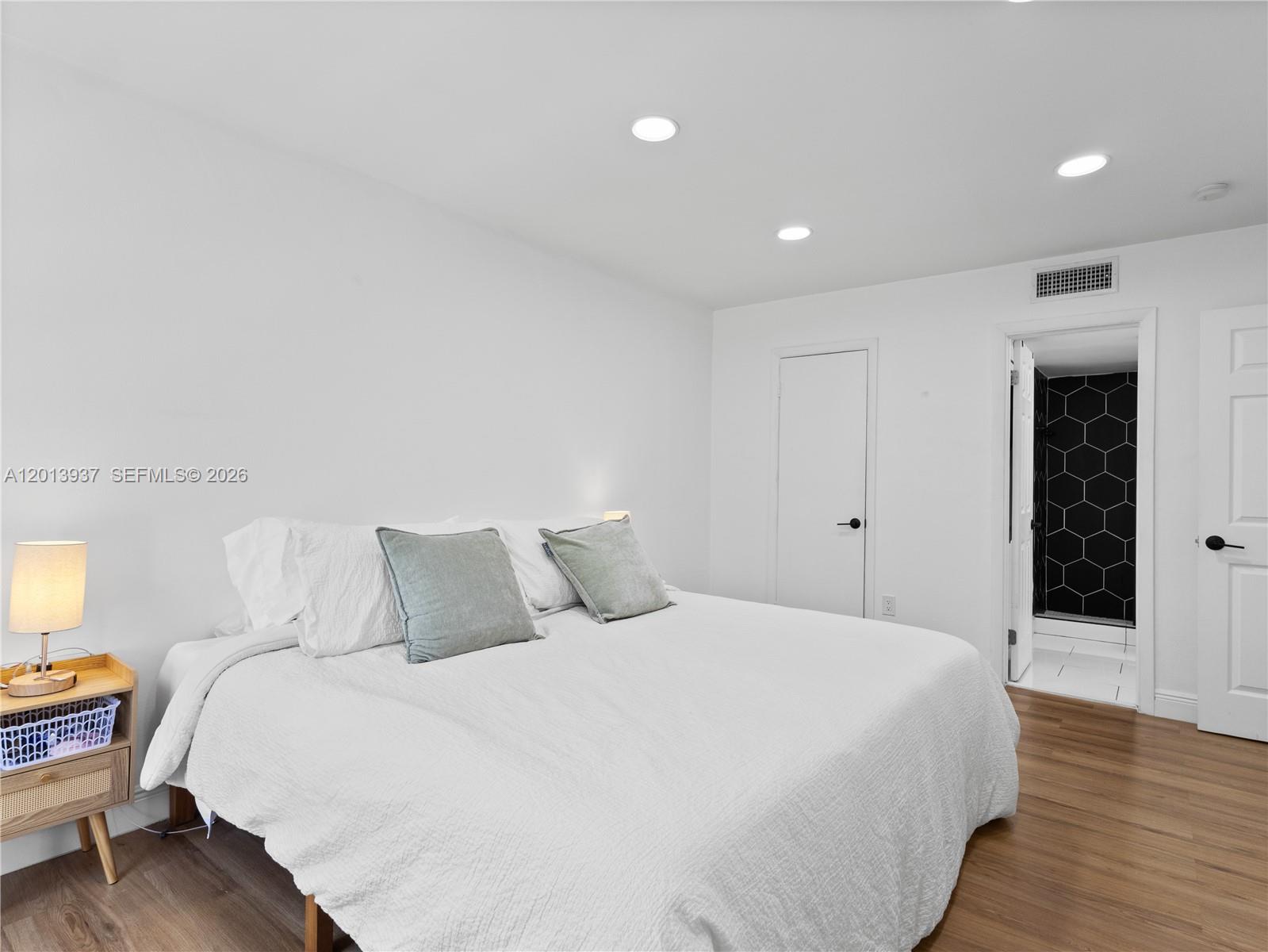 7487 Southwest 82nd Street, Unit C208 Miami, FL 33143 - Photo 15 of 28 a bedroom with a bed and a view of bedroom