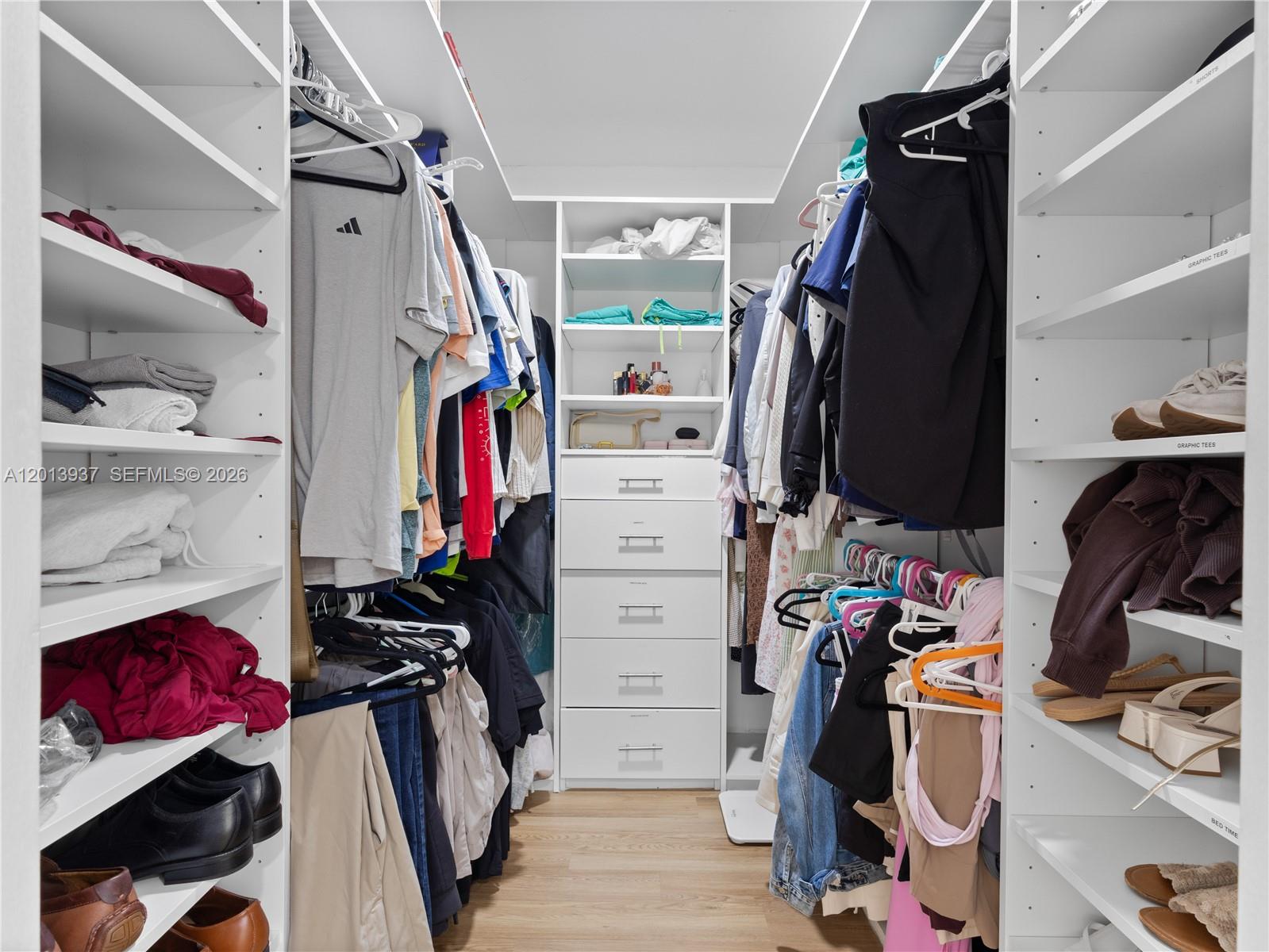 7487 Southwest 82nd Street, Unit C208 Miami, FL 33143 - Photo 16 of 28 a view of walk in closet with clothes and shoes
