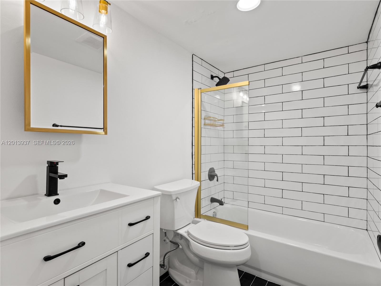 7487 Southwest 82nd Street, Unit C208 Miami, FL 33143 - Photo 17 of 28 a bathroom with a sink toilet and shower