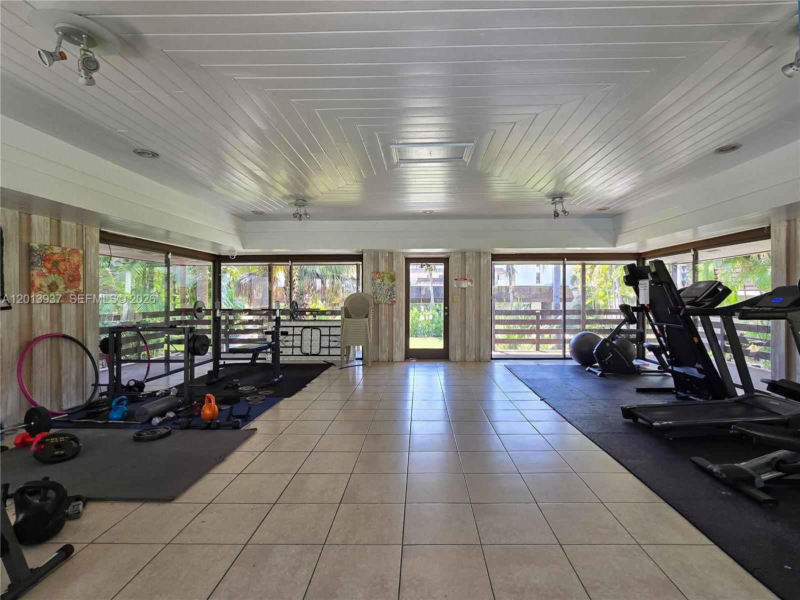 7487 Southwest 82nd Street, Unit C208 Miami, FL 33143 - Photo 24 of 28 a room with lots of chairs and a large window