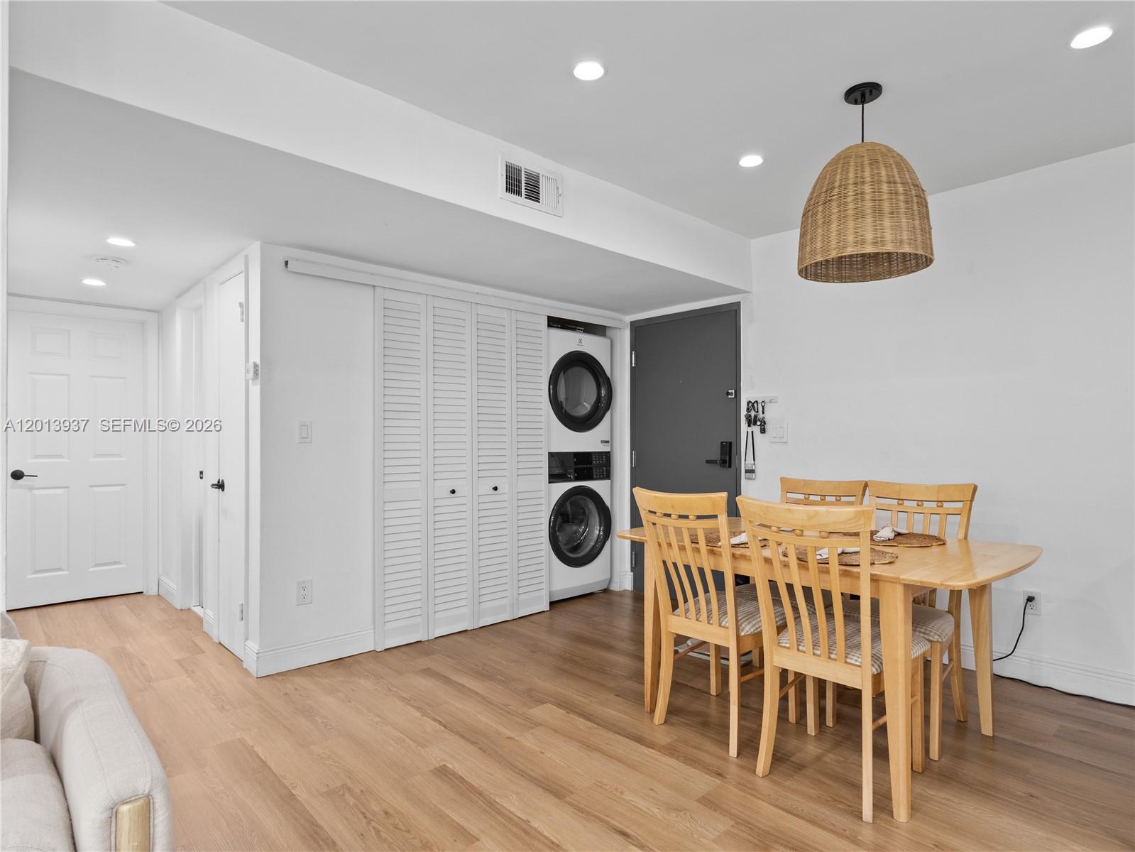 7487 Southwest 82nd Street, Unit C208 Miami, FL 33143 - Photo 7 of 28 a view of kitchen and dining room with wooden floor