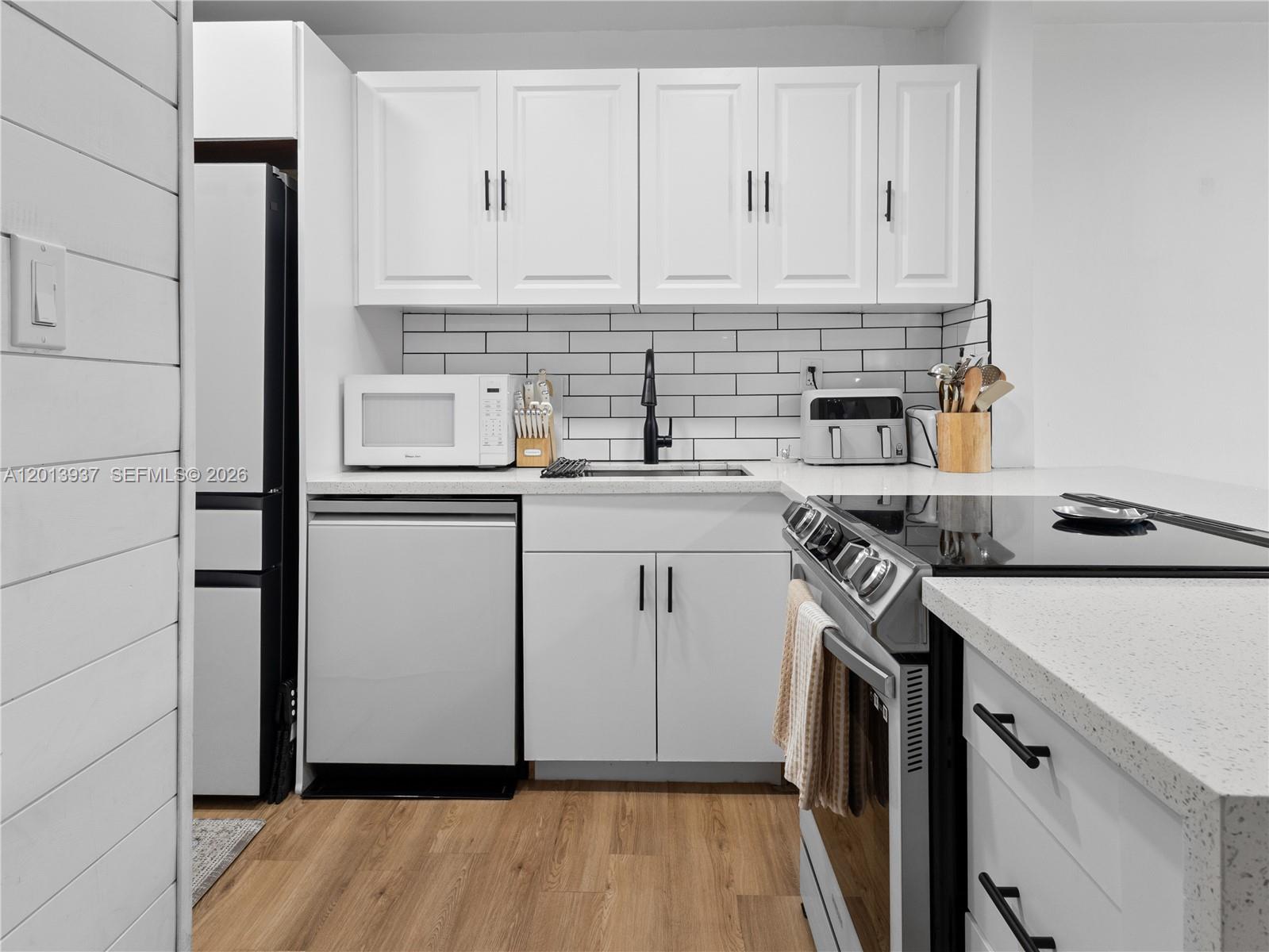 7487 Southwest 82nd Street, Unit C208 Miami, FL 33143 - Photo 10 of 28 a view of a kitchen with sink and wooden floor