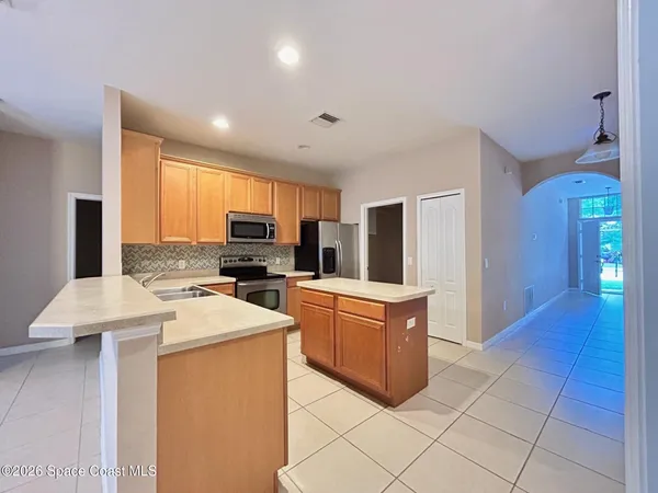 a kitchen with stainless steel appliances a refrigerator sink stove microwave and cabinets